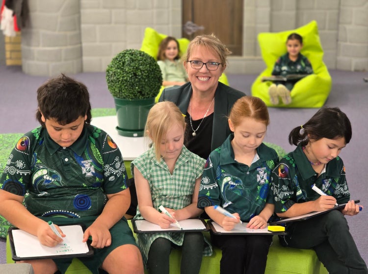 Dr Trish Grace with 4 students reading