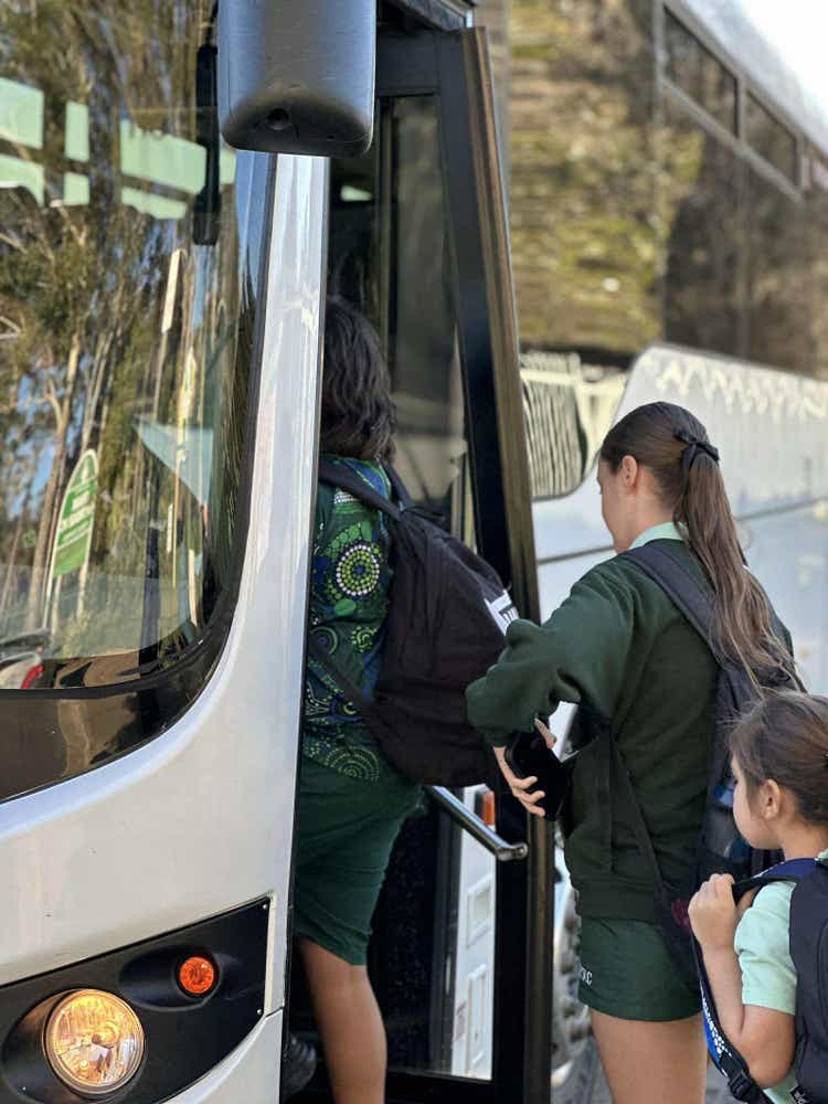 Students getting on school bus