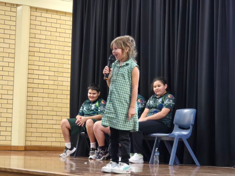 Student standing on stage debating