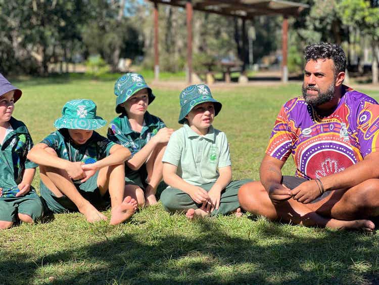 Students in yarning circle listening to Nelson Mandela